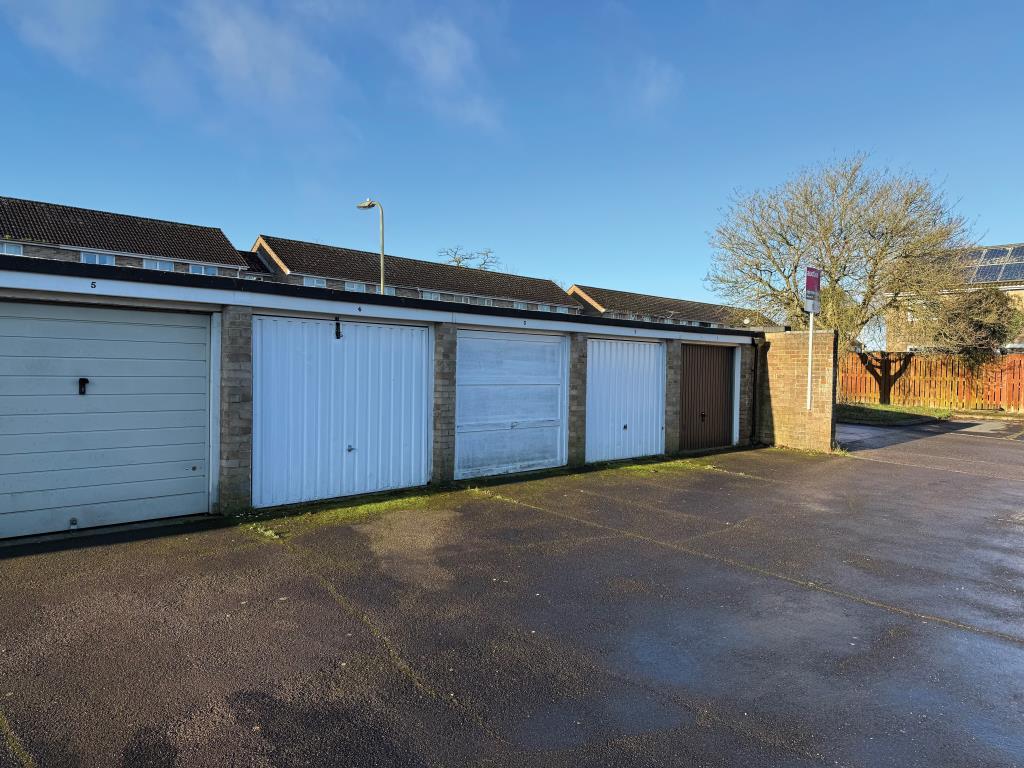 Lot: 42 - THREE FREEHOLD GARAGES WHICH FORM PART OF A LARGER BLOCK - View of garages with up and over doors